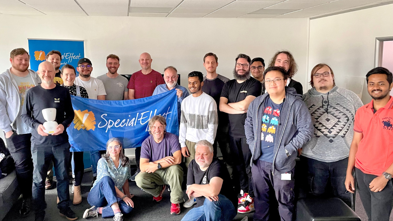 A large group of people standing around a blue banner with the words "Special Effect"